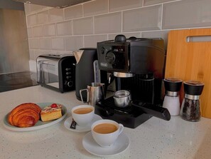 Kitchen with coffee maker, toaster, and water kettle to delightly serve you 