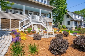 Unwind in the garden breeze from cozy Adirondack chairs.