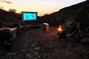 Private patio + BBQ + fire pit. Enjoy a movie by the fire pit, in our **Cinema Under the Stars** 