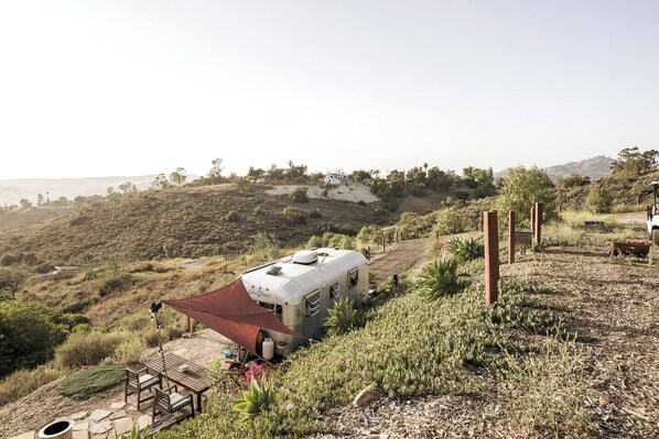 Enjoy breathtaking day and night views of over 50 acres in this stunning San Diego Canyon