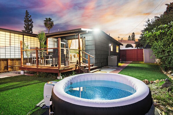 Relax and unwind in the outdoor hot tub, your personal oasis.