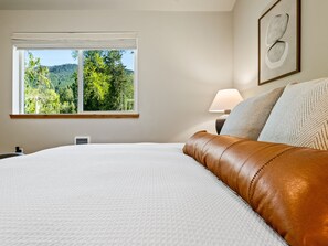 Primary suite includes king bed, organic cotton sheets and duvet cover, down duvet, Purple-brand mattress designed to enhance your comfort and relaxation. 