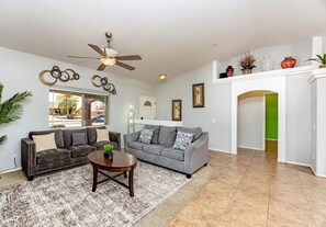Relax in the open-concept living room with a Smart TV and comfortable queen sofa sleeper