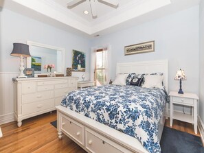 Spacious primary bedroom with a classic design and soft lighting.