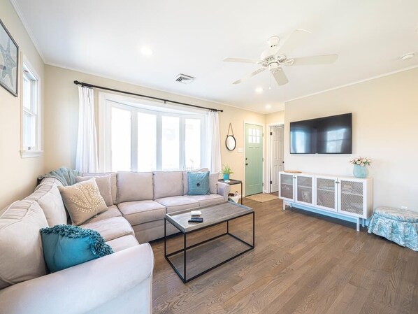 Comfortable seating, elegant decor, and a large TV make this the perfect place to unwind.