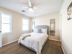 A well-lit bedroom with a relaxing and elegant design.