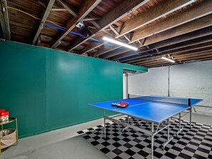 Epic ping-pong action!  This basement game room is 🔥.  Ready to serve up some serious fun?  #GameOn