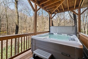 Hot Tub on the Covered Deck Surrounded with Woods
