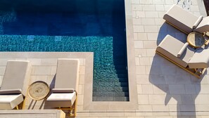 Sensory pool design featuring comfy sunloungers.