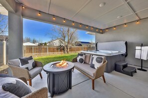 Relax under the covered patio, gather around the cozy firepit, soak in the 7-person hot tub, or fire up the gas BBQ grill - all in a private and inviting backyard setting.