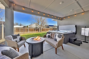 Relax under the covered patio, gather around the cozy firepit, soak in the 7-person hot tub, or fire up the gas BBQ grill - all in a private and inviting backyard setting.