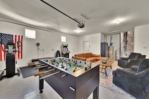 Endless entertainment awaits in the game room! Challenge friends to a round of foosball, enjoy classic arcade games, or break a sweat in the workout space. Sink into the cozy seating area and catch the game or your favorite shows on the 65” smart TV.