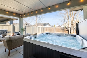 Step outside and sink into pure relaxation in the luxurious 7-person hot tub, perfectly situated under the covered patio just beyond the sliding door—ideal for unwinding day or night.