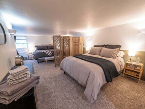 One very large bedroom has 1 king bed & 1 queen bed, both with luxury linens, memory foam toppers & down comforters. Each bed area has its own full size dresser. 