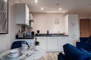 A perfect setup for home-cooked meals or takeaways, with a modern dining table for a cosy dining experience.
