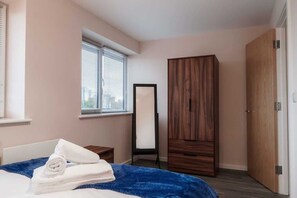 A peaceful bedroom with a comfy double bed and spacious wardrobe to keep everything neatly stored.