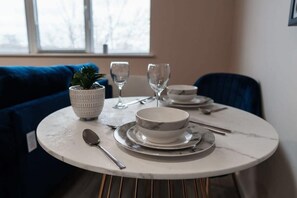 Enjoy a meal at the chic dining table, designed for comfort and style during your stay.