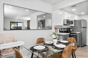 Dining area (seats 4), high chair and fully-functional kitchenette with basic cooking ware