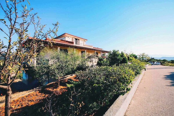 Facade of the property along with garden