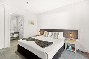 Light-filled room with luxe linens and ample storage.