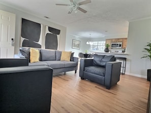 The living area is open to the kitchen and features a 65-inch Samsung Smart TV with access to Netflix and other apps (cable and streaming services not provided).