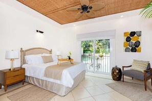 First bedroom with pool view and queen bed.