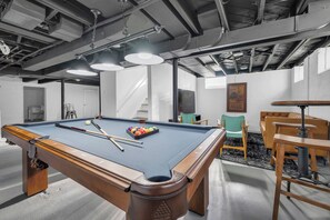 Game room with a professionally installed pool table & light. 65" 4k Smart TV.