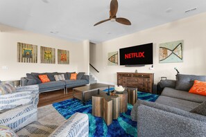 This lower-level living room is perfect for relaxing, watching Netflix, or playing games after a day on the lake.