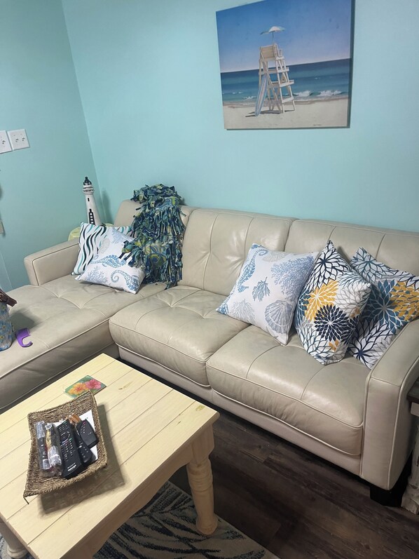 Sectional in living room.  TV.  Ceiling fan and light on remote