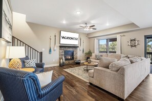 The Main Level Comfortable Living Space Features Cable TV, a Fireplace, and Deck Access