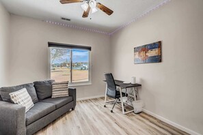 Work or unwind in this versatile space featuring a dedicated workspace with scenic views and a cozy seating area for ultimate comfort.





