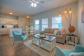 The inviting living room boasts plush seating and TV.