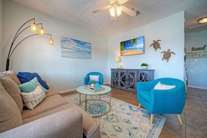 Coastal-inspired décor, plush seating, and a sleeper sofa in the living room.