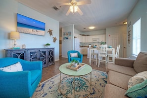 Coastal-inspired décor, plush seating, and a sleeper sofa in the living room.