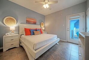 The primary bedroom features a king bed, TV, access to the balcony, and an ensuite bathroom.