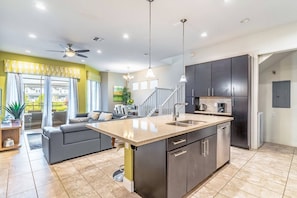 Bright and open floor plan gives you access to the kitchen, dining, living room, laundry room and the home's private pool!
