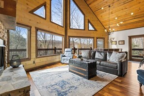 Our open-floor living room with soaring vaulted ceilings invites you to relax in style!