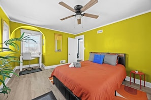 Bedroom 2: Featuring earthy mustard-colored walls and modern decor, this bedroom offers a king-size bed and a cozy reading nook.