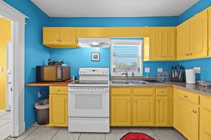 Kitchen: A stylish and functional kitchen with everything you need for your stay, featuring retro-inspired decor and modern appliances.