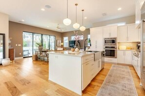 Enjoy stunning views from this cozy retreat, featuring a modern kitchen for delightful family meals, featuring a SubZero built-in fridge and ample space for preparing meals.