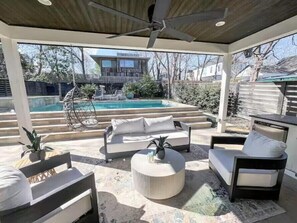Your private outdoor oasis! Relax on the shaded patio with comfortable out door seating, overlooking the sparkling pool. Perfect for lounging and enjoying the sunshine.