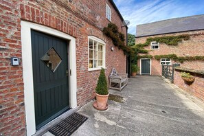 Dairy Cottage - entrance to the cottage in the farm courtyard