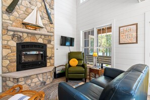 blue cottage living area with surround Lake views, fireplace and smart tv