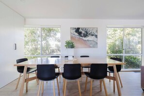 Share home-cooked meals or a takeaway feast at the wooden dining table with seating for eight.
