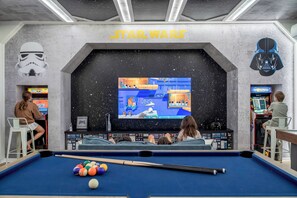 Star Wars game room with TV, arcade, and pool—perfect for kids and families