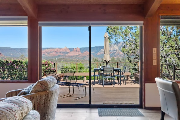 The main living area boasts a vaulted ceiling, and a window wall facing east, offering unparalleled views.