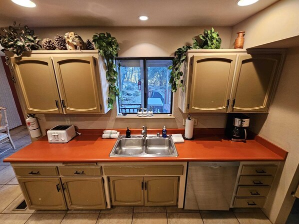 Kitchen Sink with view of back porch and pool.