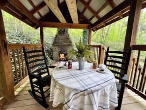 Dine under the gazebo and unwind in classic rocking chairs by the cozy outdoor fireplace — the perfect spot to relax and enjoy the mountain air.