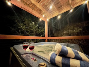 Soak under the stars in your private hot tub, perched above Cove Creek with twinkling string lights overhead. Let the sounds of the rushing water and the peaceful seclusion melt your stress away.