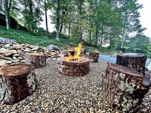 Cozy up around the rustic firepit, complete with log stump seating, perfect for roasting marshmallows, sharing stories, or relaxing under the stars.